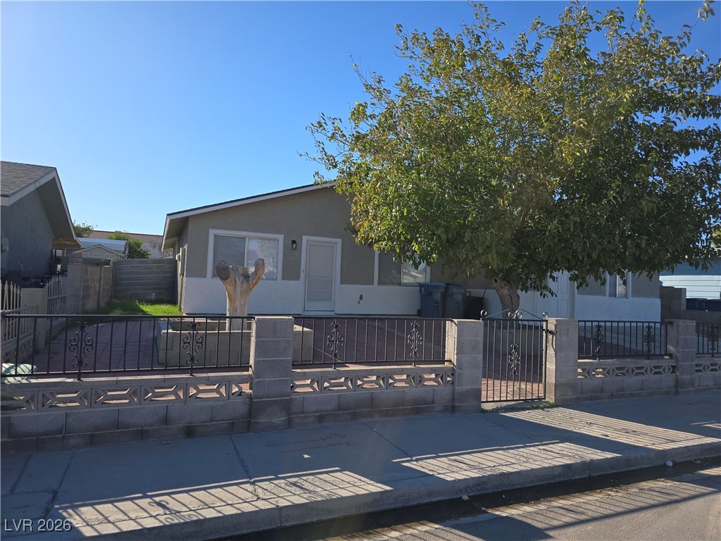 4219 Studio Street Las Vegas, NV 89115 - Photo 29 of 33 View of front of house featuring a fenced front yard, stucco siding, and a gate
