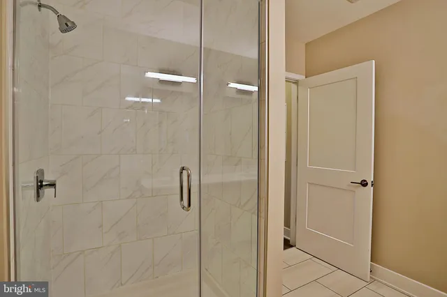 a bathroom with a glass shower door