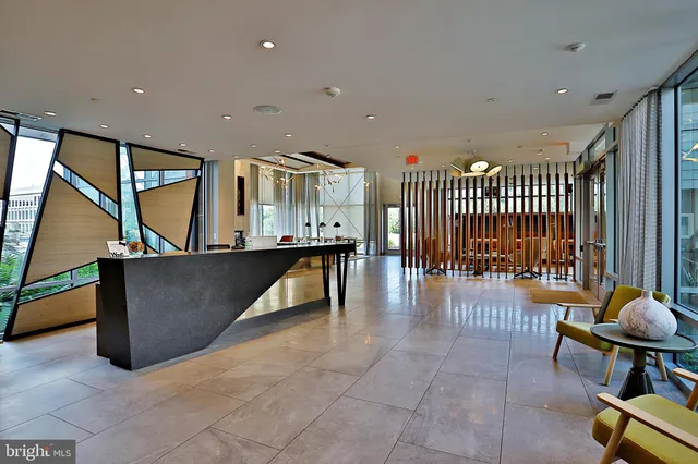 a lobby with furniture and stairs