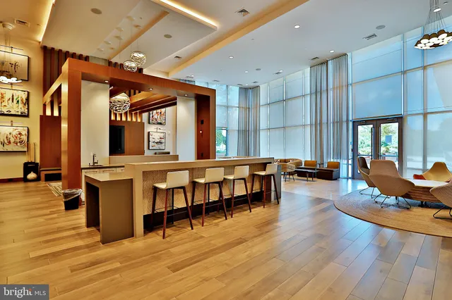 a living room with furniture a wooden floor and chandelier