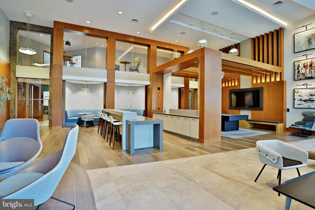 a living room with furniture a rug and a large window