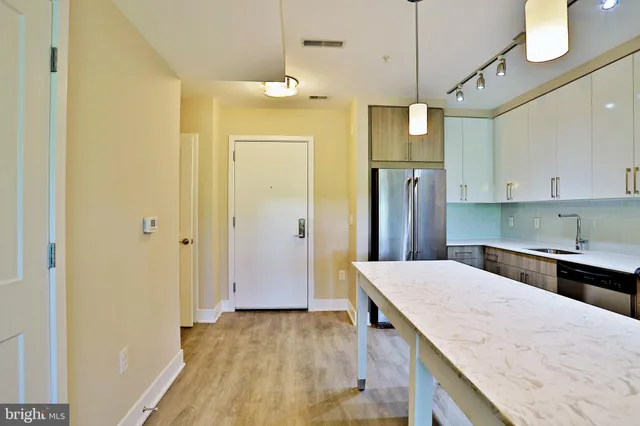 a kitchen with a refrigerator a sink and cabinets