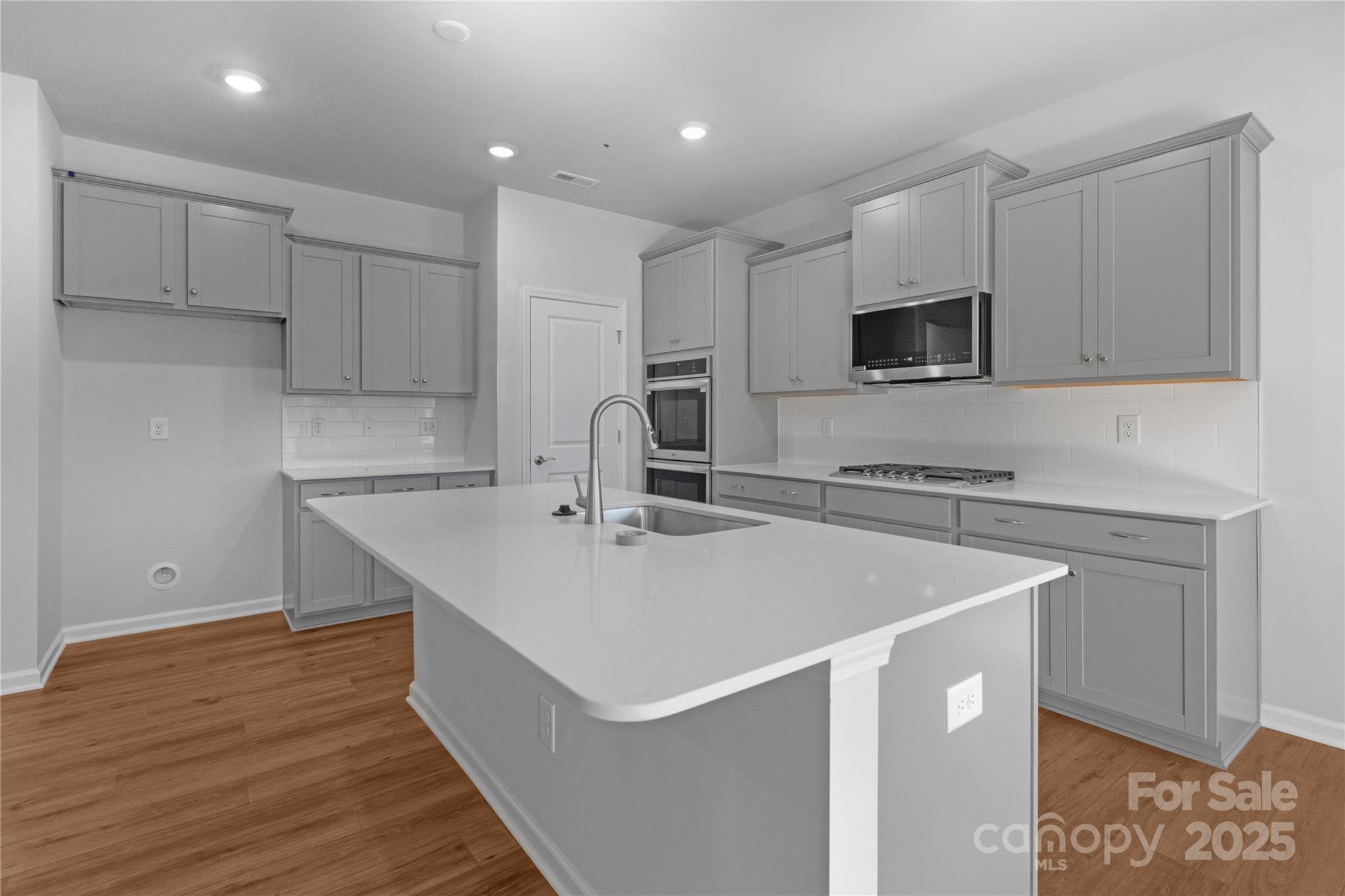 3322 Amarillo Court Lancaster, SC 29720 - Photo 13 of 30 a kitchen with stainless steel appliances a microwave sink and cabinets