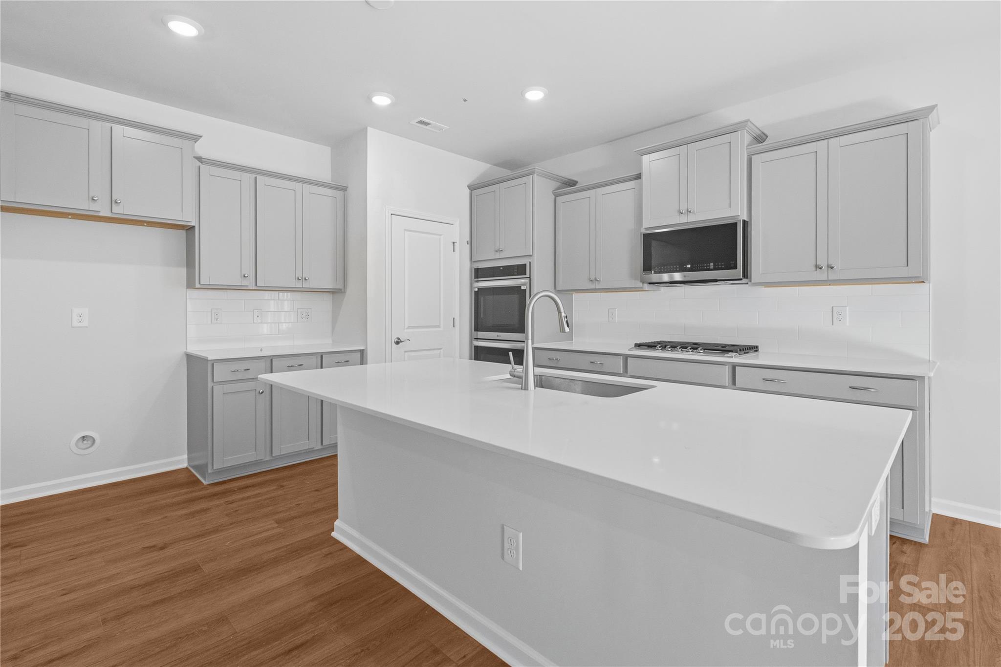 3322 Amarillo Court Lancaster, SC 29720 - Photo 14 of 30 a kitchen with kitchen island white cabinets and stainless steel appliances