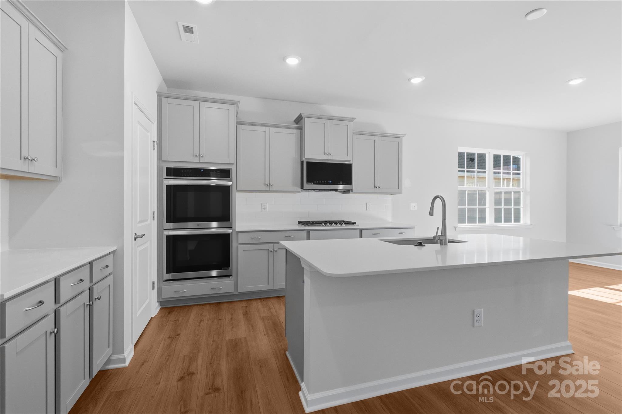 3322 Amarillo Court Lancaster, SC 29720 - Photo 18 of 30 a kitchen with stainless steel appliances granite countertop a sink stove and refrigerator
