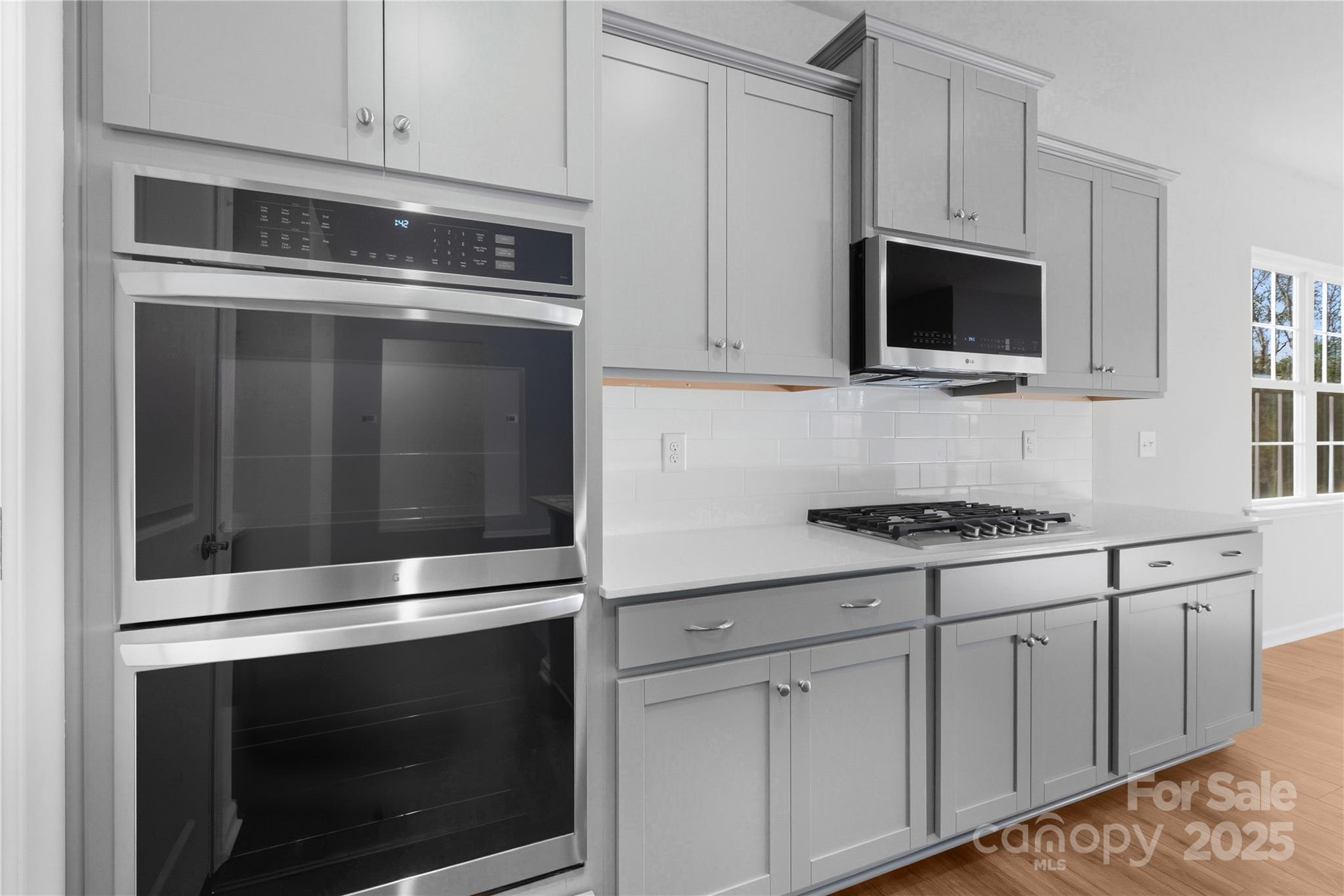 3322 Amarillo Court Lancaster, SC 29720 - Photo 20 of 30 a kitchen with stainless steel appliances white cabinets and a stove a oven with white countertops