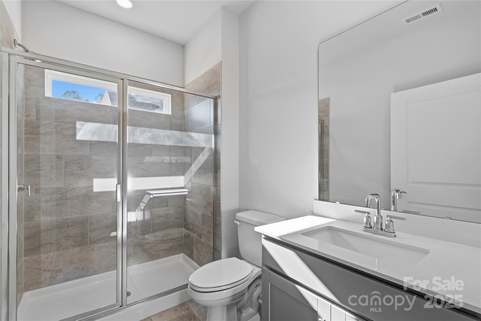 3322 Amarillo Court Lancaster, SC 29720 - Photo 24 of 30 a bathroom with a granite countertop sink a toilet and shower