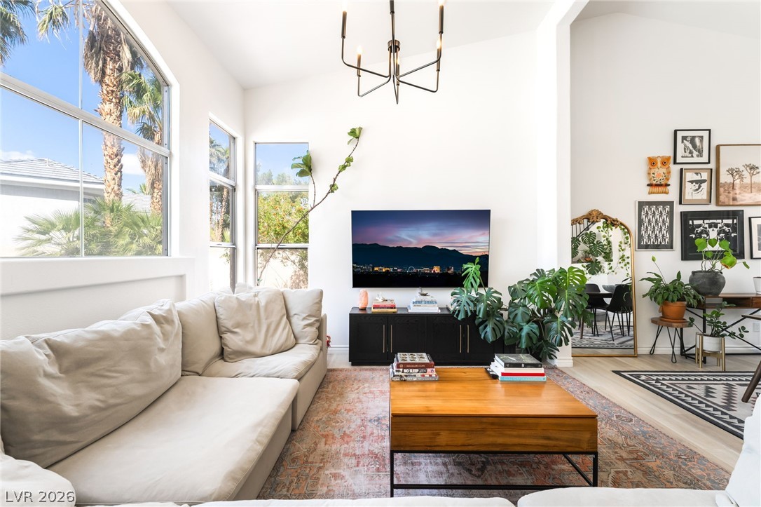 1941 Ivy Point Lane Las Vegas, NV 89134 - Photo 5 of 21 This naturally illuminated living room features soaring vaulted ceilings and expansive windows, creating an airy and inviting atmosphere.