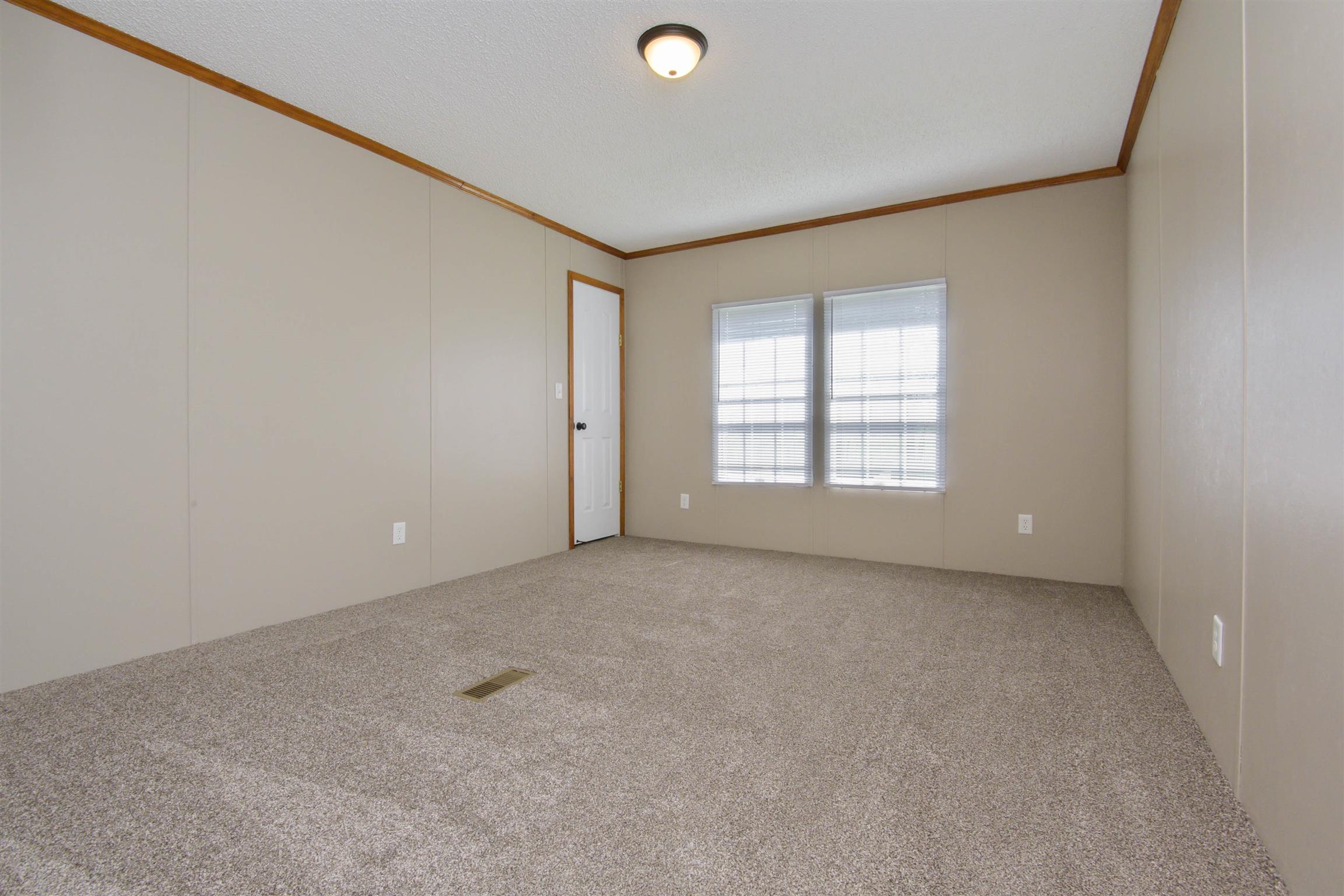 4489 Goodman Road Adams, TN 37010 - Photo 12 of 30 an empty room with windows & cabinet