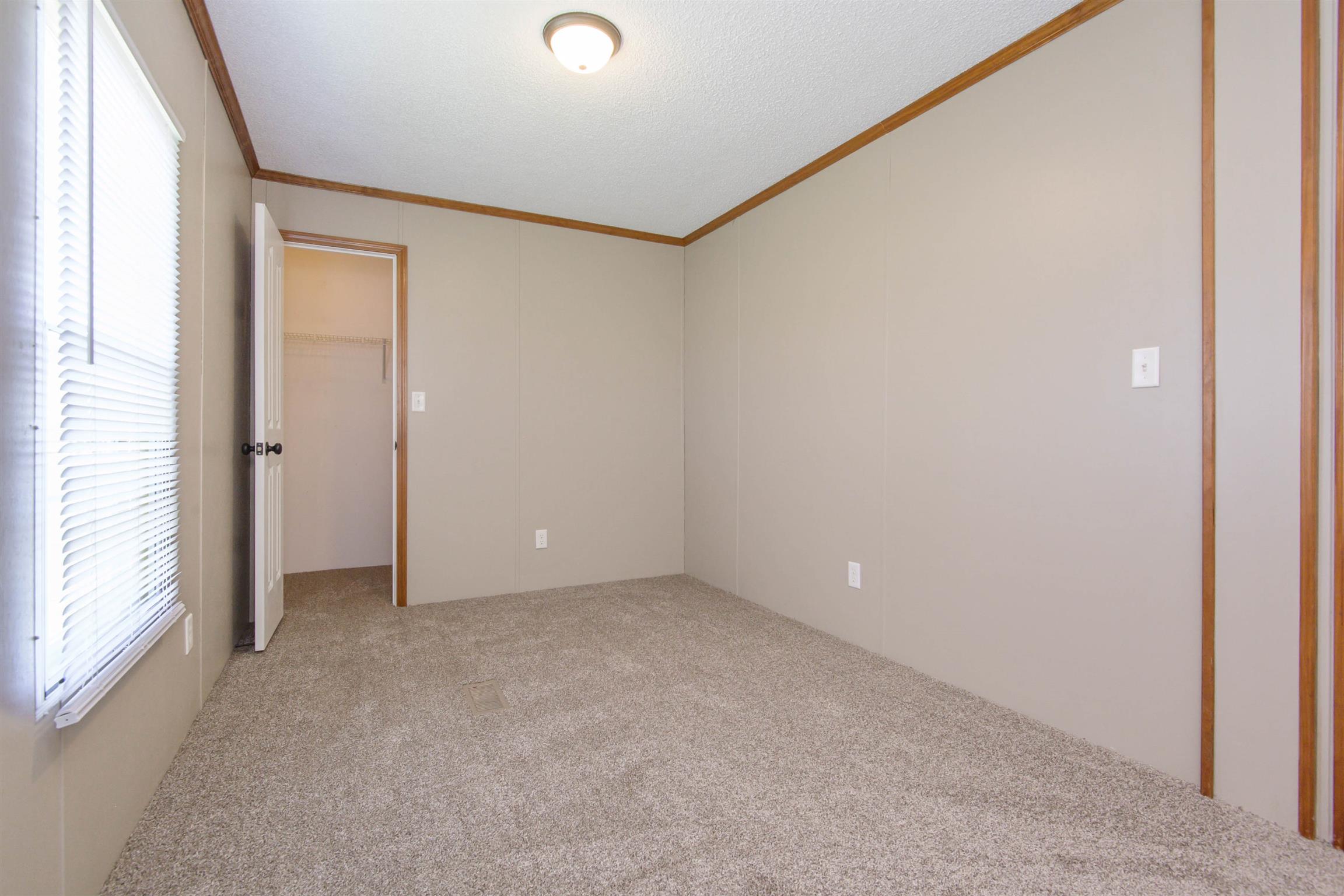 4489 Goodman Road Adams, TN 37010 - Photo 16 of 30 an empty room with windows and closet