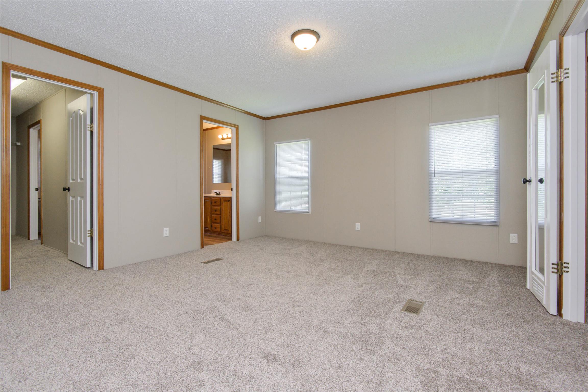 4489 Goodman Road Adams, TN 37010 - Photo 18 of 30 an empty room with windows and closet