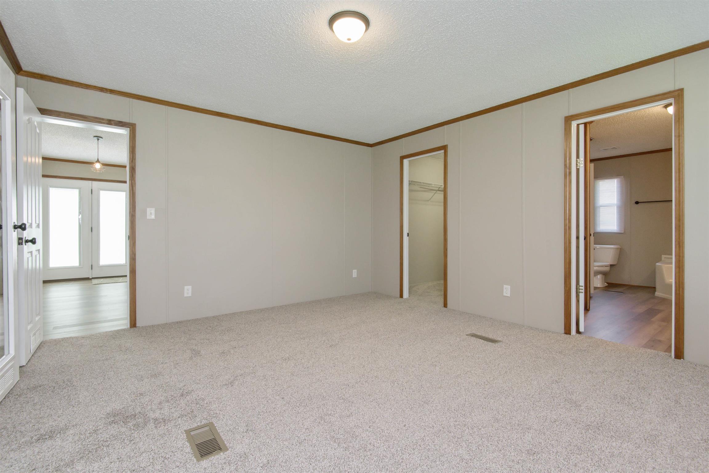 4489 Goodman Road Adams, TN 37010 - Photo 19 of 30 an empty room with windows and closet