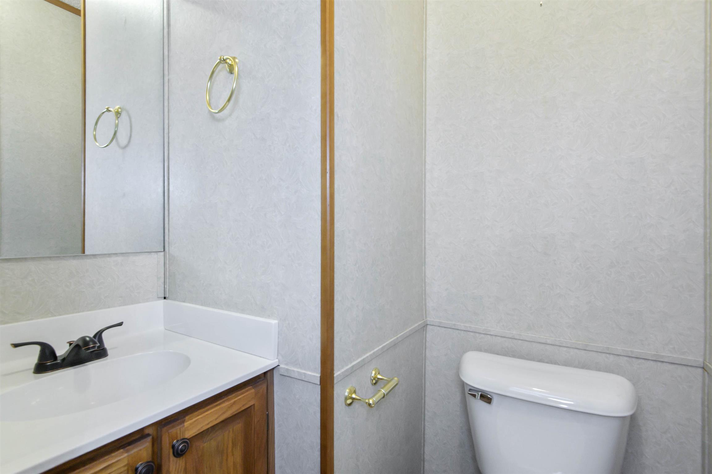 4489 Goodman Road Adams, TN 37010 - Photo 25 of 30 a bathroom with a sink and toilet