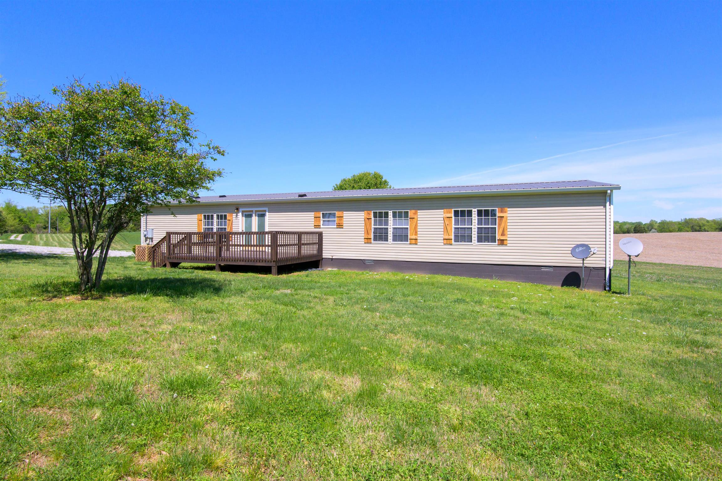 4489 Goodman Road Adams, TN 37010 - Photo 27 of 30 a view of a house with a backyard