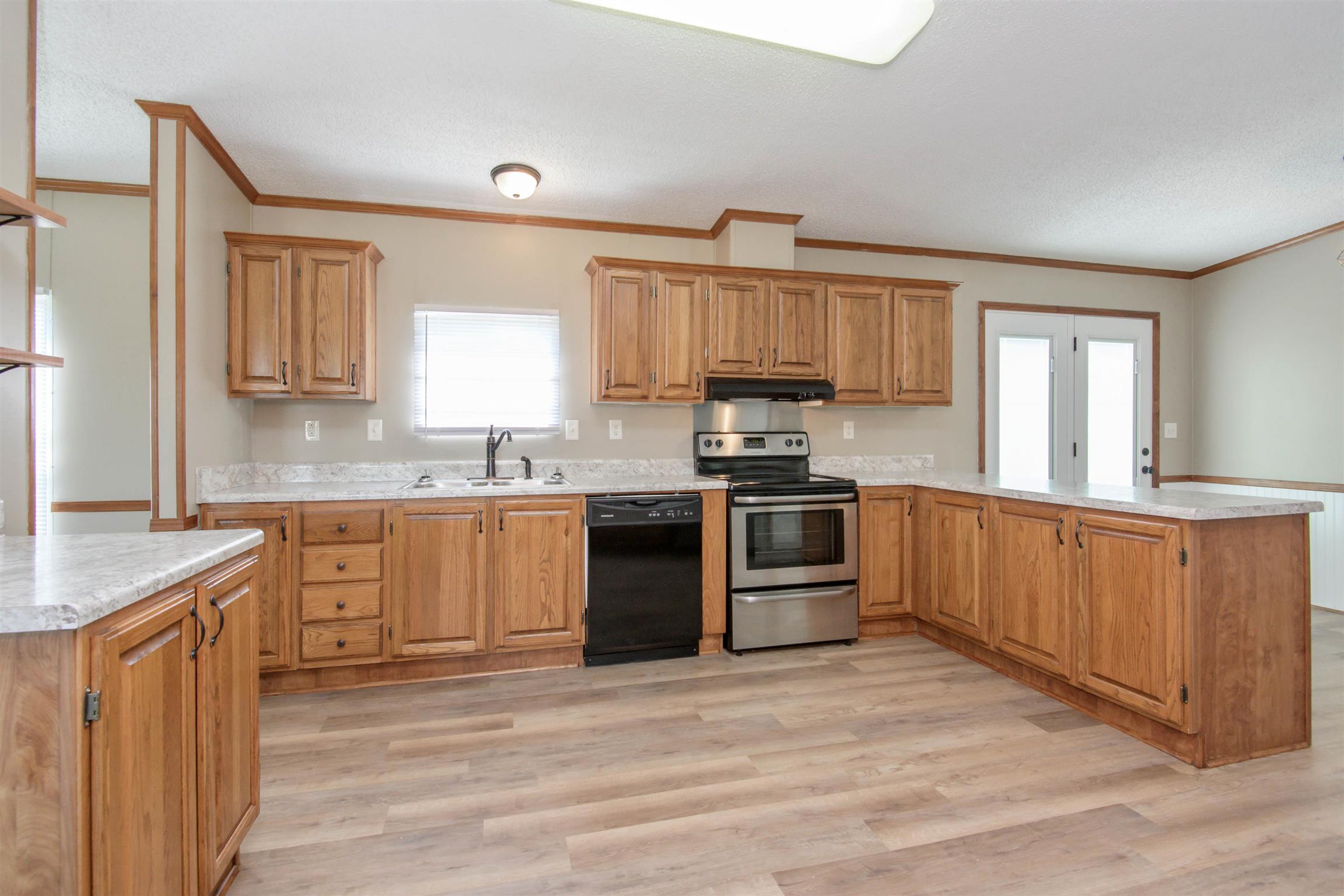 4489 Goodman Road Adams, TN 37010 - Photo 8 of 30 a kitchen with granite countertop a sink cabinets and stainless steel appliances