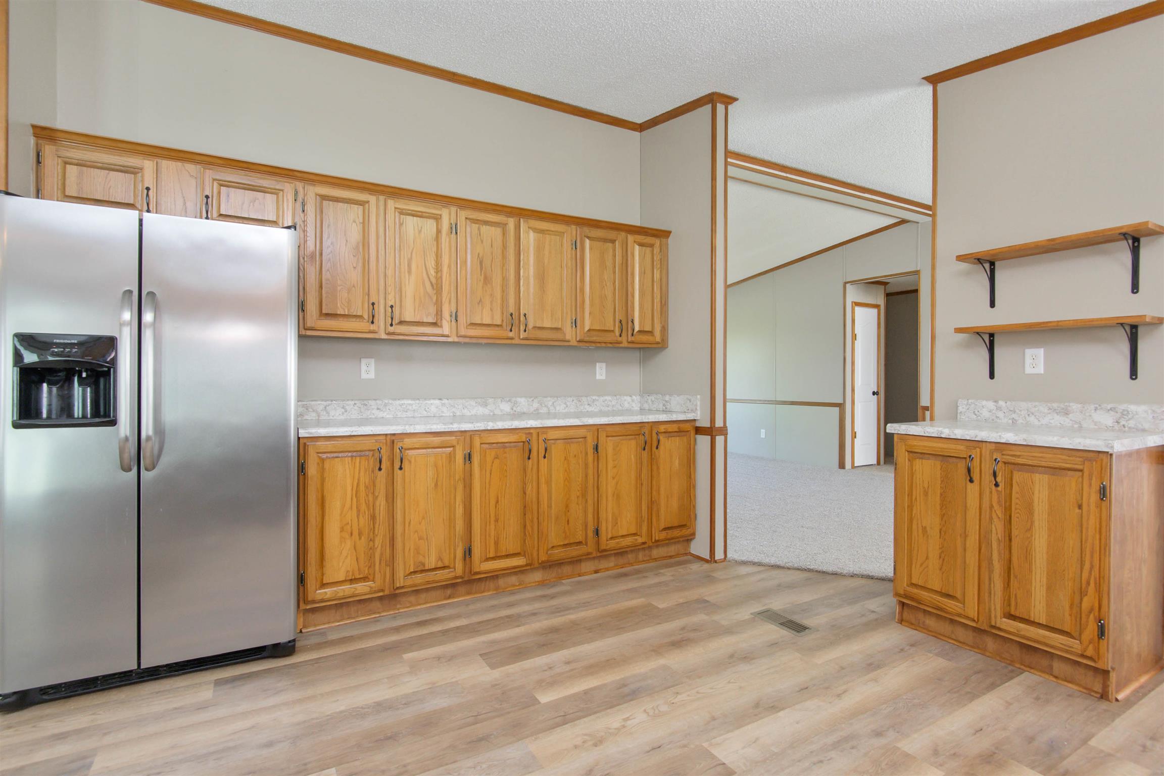 4489 Goodman Road Adams, TN 37010 - Photo 9 of 30 a kitchen with stainless steel appliances granite countertop a refrigerator and a sink