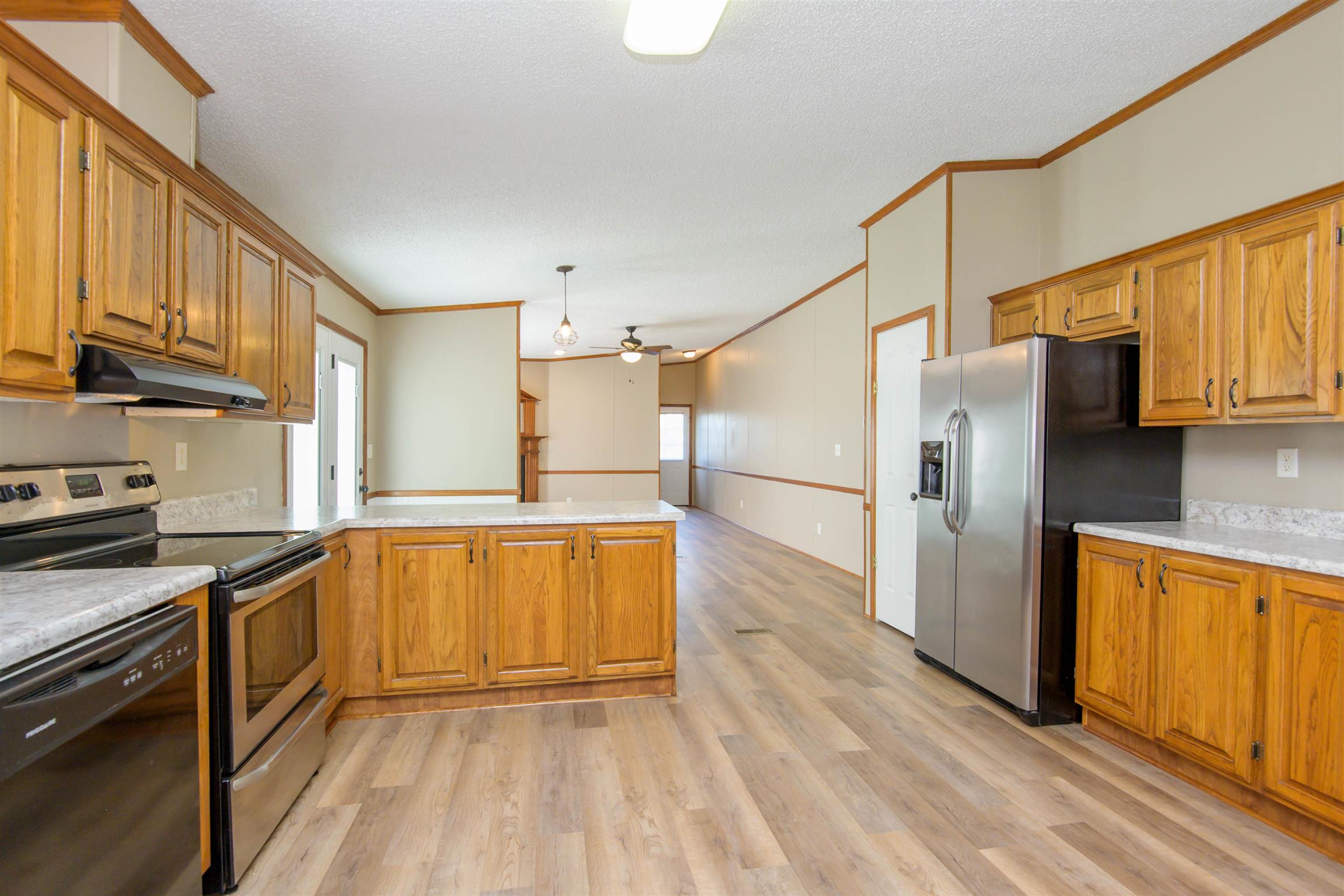 4489 Goodman Road Adams, TN 37010 - Photo 10 of 30 a kitchen with stainless steel appliances granite countertop a refrigerator a stove and a sink