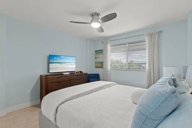 a bedroom with a bed and a lamp