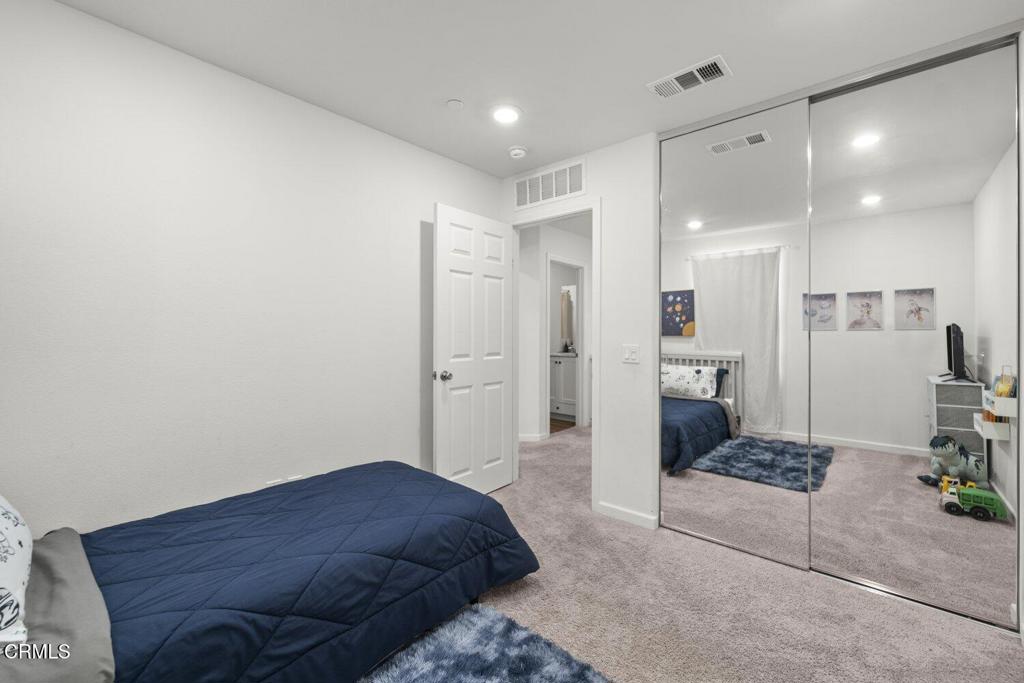 586 Apricot Lane Fillmore, CA 93015 - Photo 24 of 38 a spacious bedroom with a bed and a view of kitchen