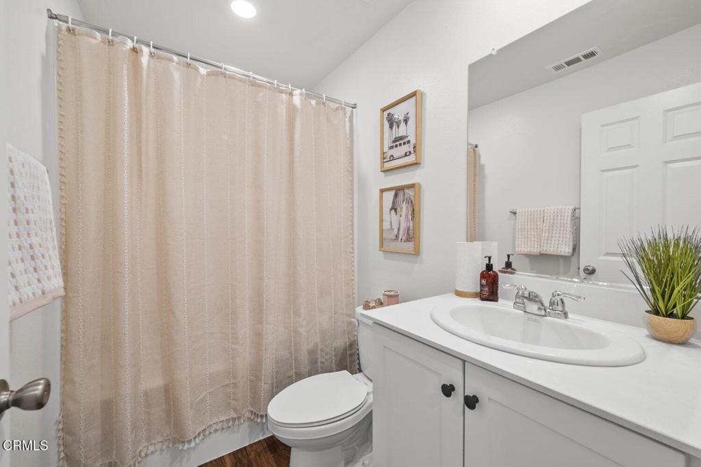 586 Apricot Lane Fillmore, CA 93015 - Photo 25 of 38 a bathroom with a sink a toilet and shower curtain