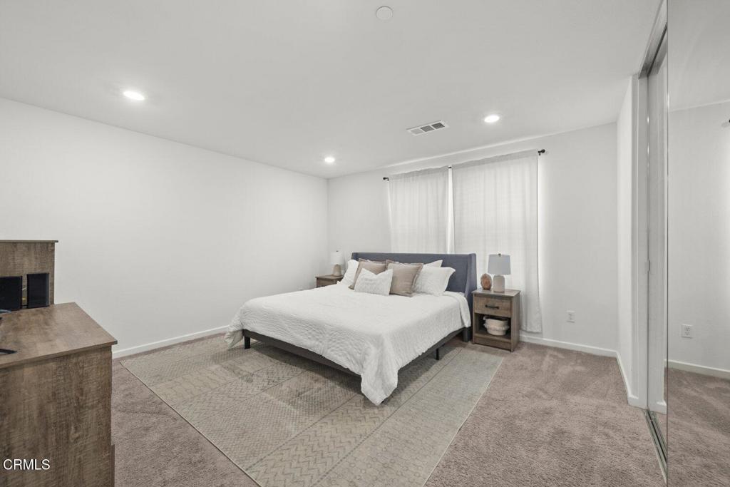 586 Apricot Lane Fillmore, CA 93015 - Photo 26 of 38 a spacious bedroom with a bed and a tv