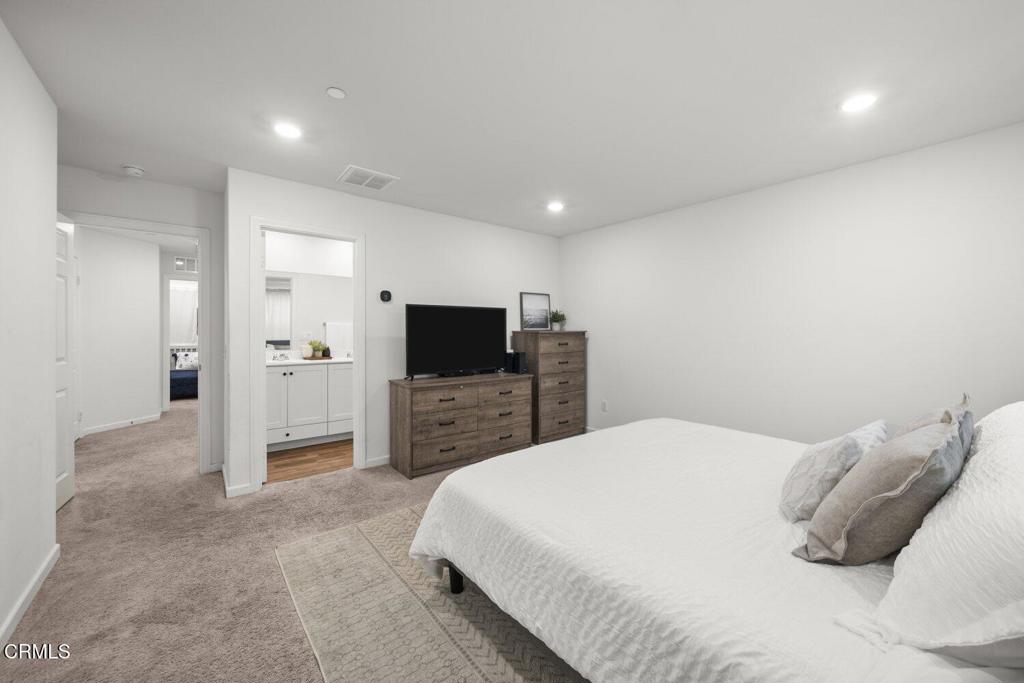 586 Apricot Lane Fillmore, CA 93015 - Photo 27 of 38 a large bedroom with a bed and a flat screen tv