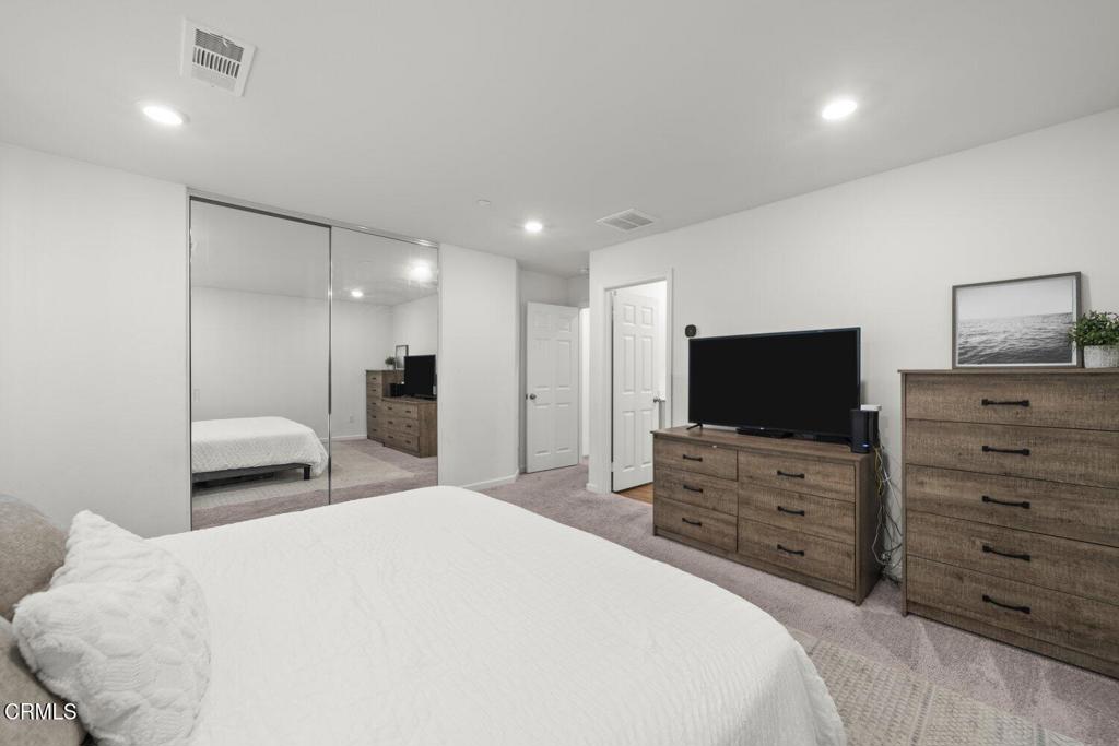 586 Apricot Lane Fillmore, CA 93015 - Photo 28 of 38 a bedroom with a bed and a flat screen tv in white dresser