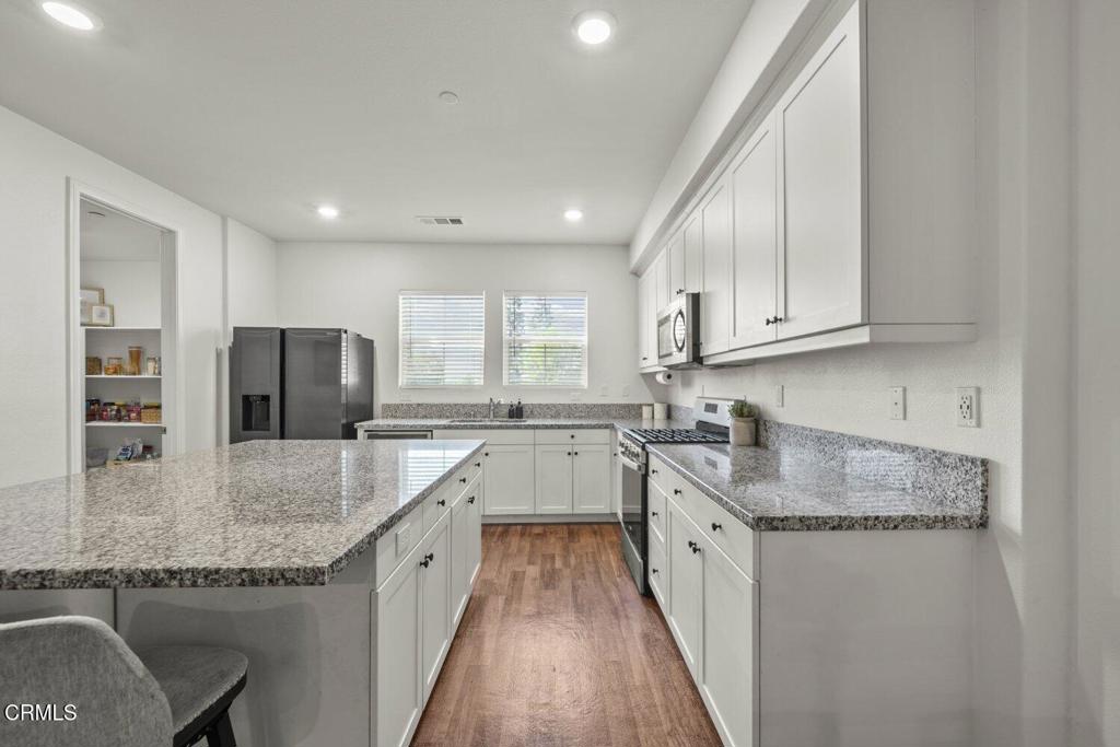 586 Apricot Lane Fillmore, CA 93015 - Photo 7 of 38 a large kitchen with stainless steel appliances granite countertop a sink stove and refrigerator