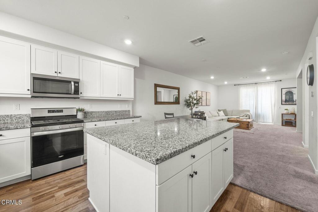 586 Apricot Lane Fillmore, CA 93015 - Photo 8 of 38 a kitchen with stainless steel appliances granite countertop a sink stove and cabinets