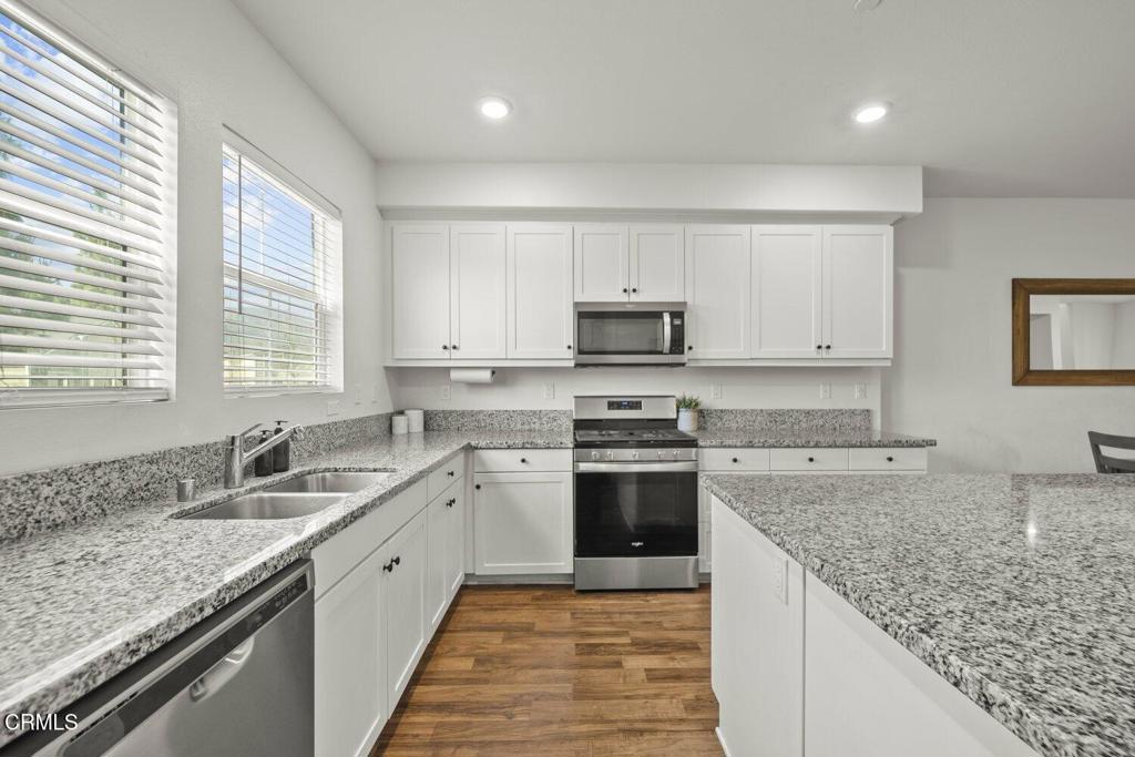 586 Apricot Lane Fillmore, CA 93015 - Photo 9 of 38 a kitchen with stainless steel appliances granite countertop a sink stove and cabinets