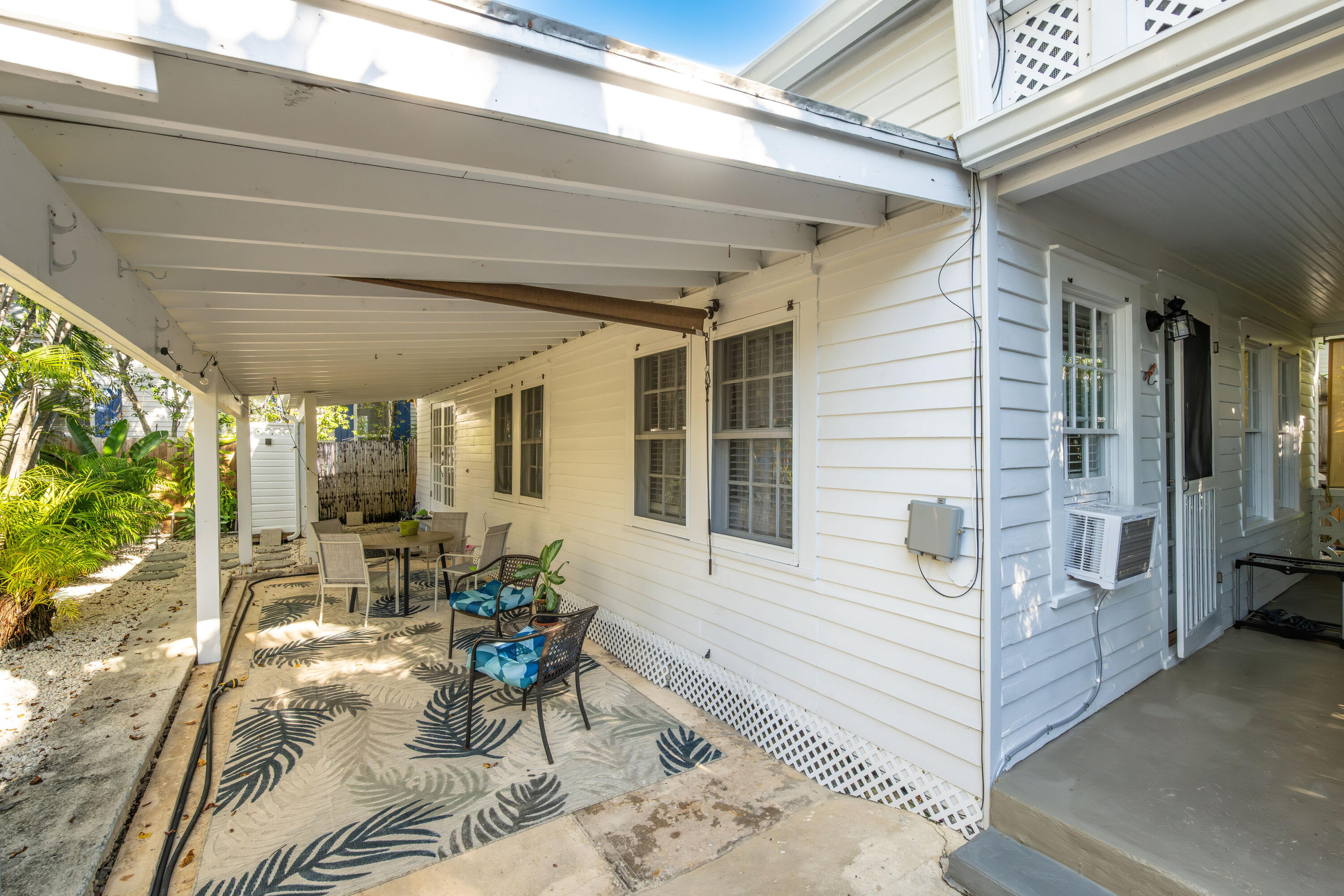 1209 Pearl Street Key West, FL 33040 - Photo 2 of 22 a view of a patio with table and chairs and potted plants