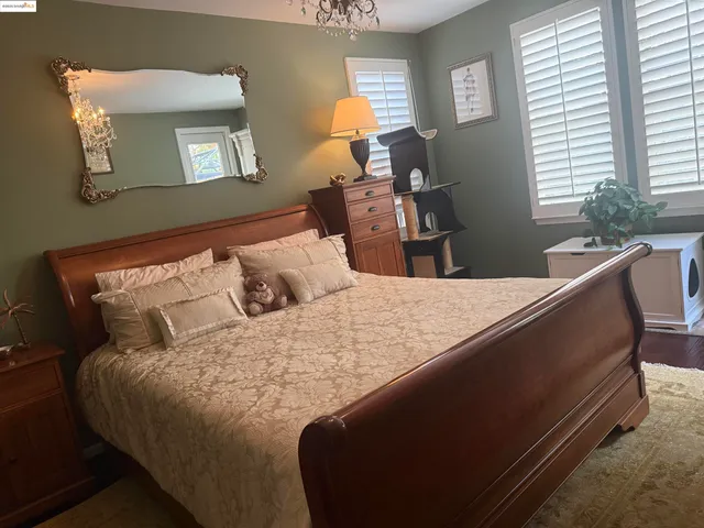 a bedroom with a bed and window