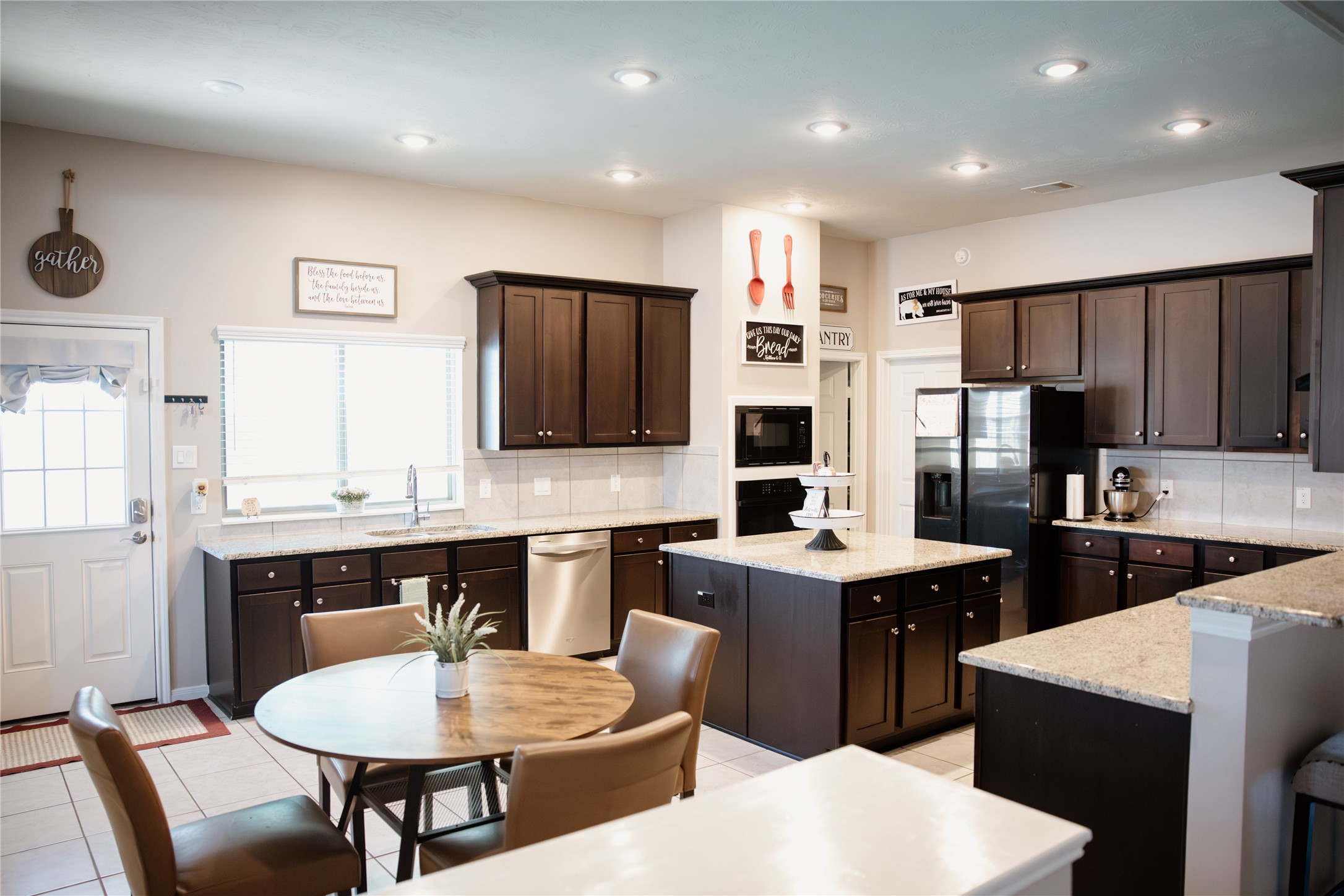 6438 Grapevine Bend Manvel, TX 77578 - Photo 4 of 36 Generous Cabinetry throughout this elegant kitchen for optimal organization with breakfast area and spacious Island