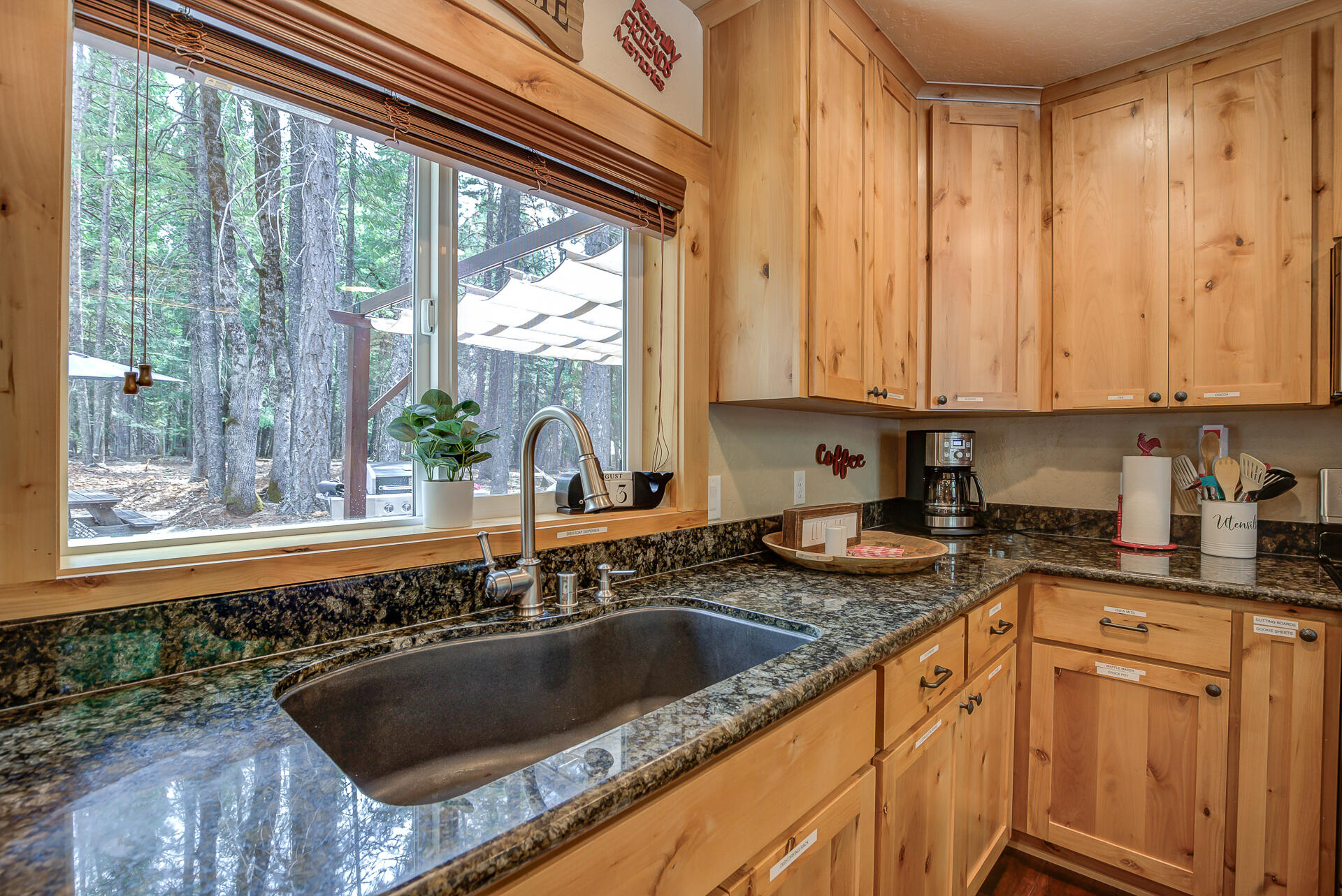 34607 Mountain Haven Road Shingletown, CA 96088 - Photo 16 of 63 a kitchen with granite countertop a sink and a window