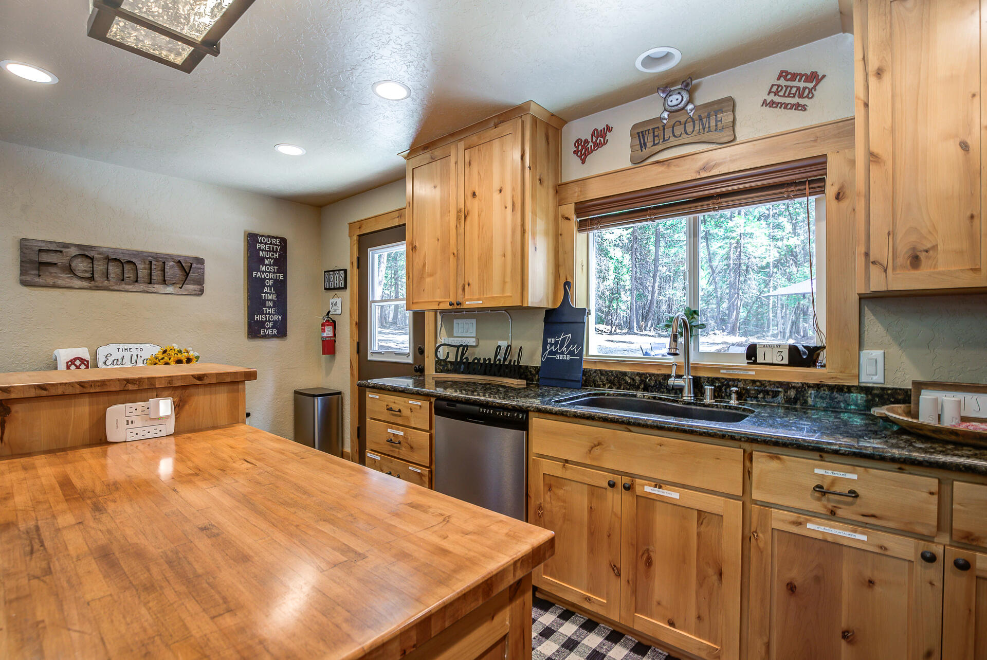 34607 Mountain Haven Road Shingletown, CA 96088 - Photo 17 of 63 a kitchen with granite countertop a stove a sink a refrigerator and wooden cabinets
