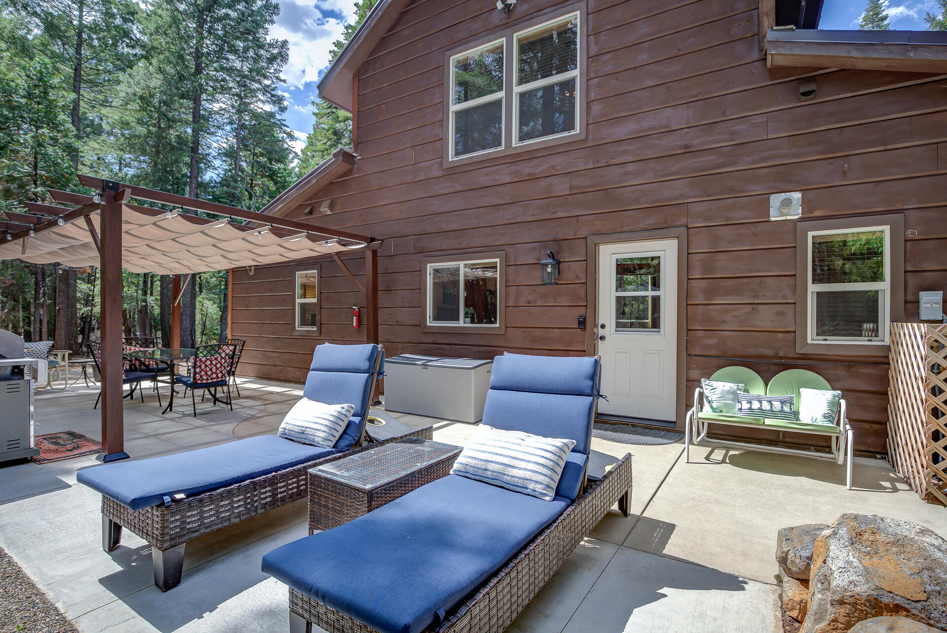 34607 Mountain Haven Road Shingletown, CA 96088 - Photo 38 of 63 a outdoor space with patio couches and a fireplace