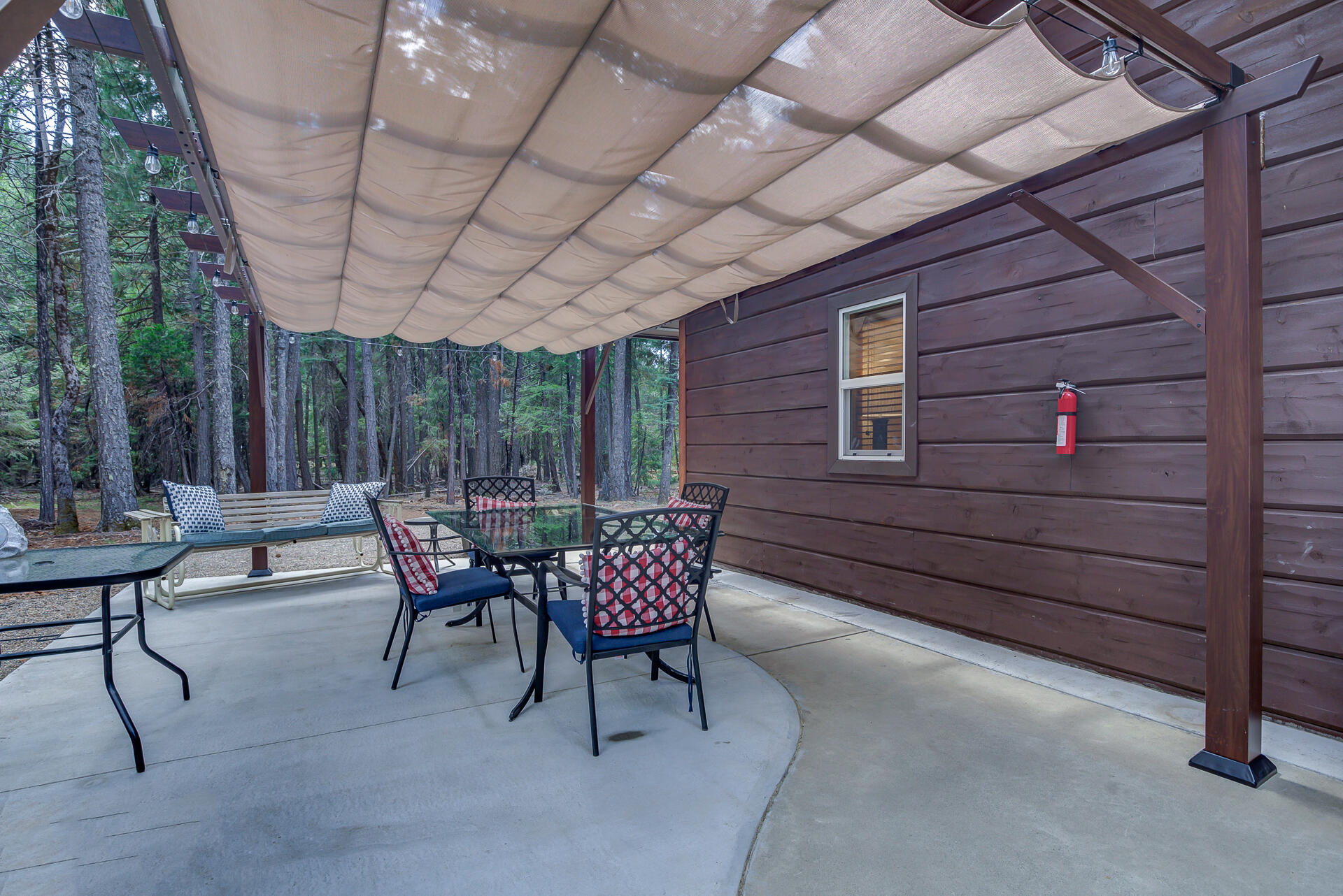 34607 Mountain Haven Road Shingletown, CA 96088 - Photo 40 of 63 a view of a patio with table and chairs and potted plants