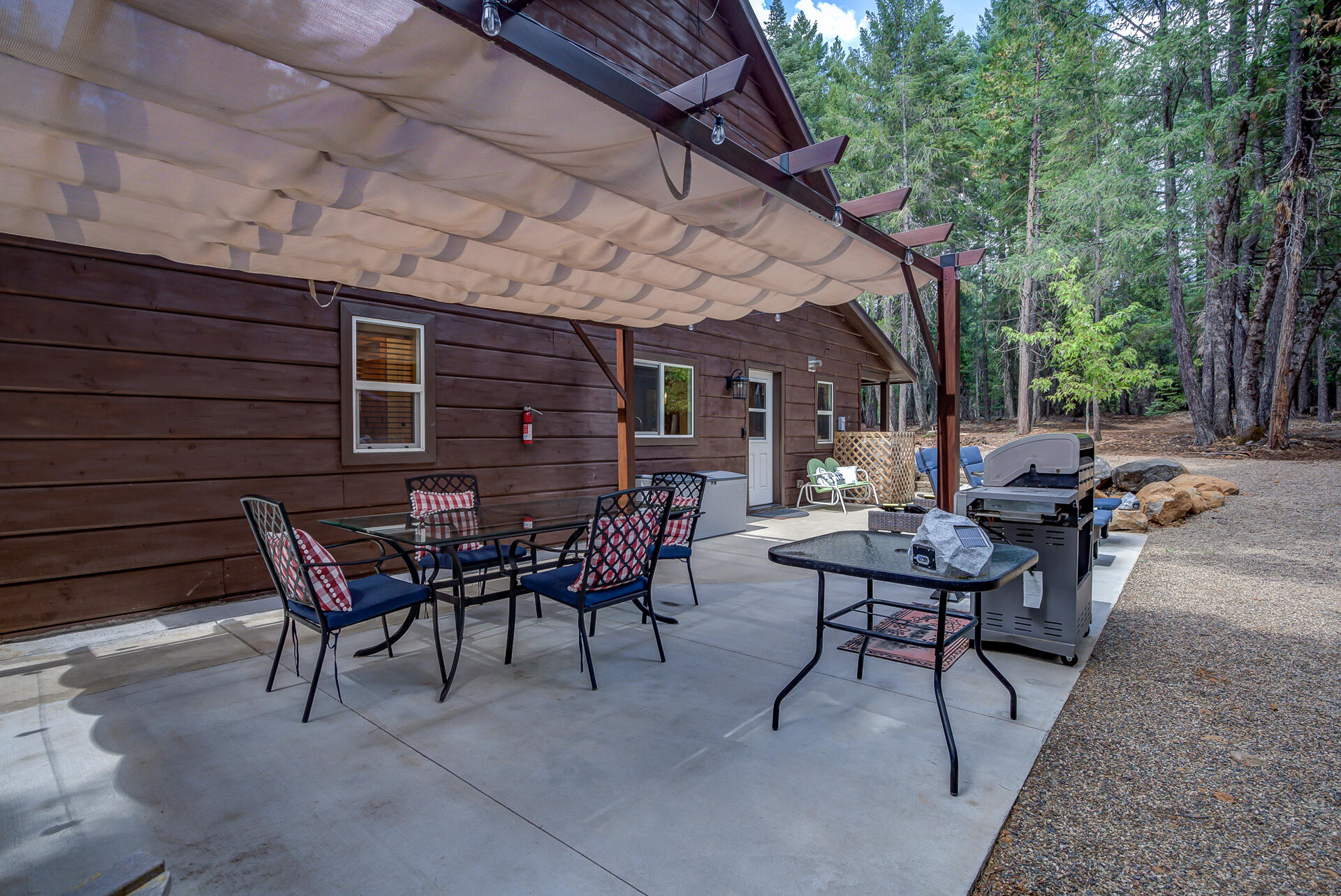 34607 Mountain Haven Road Shingletown, CA 96088 - Photo 41 of 63 a view of a patio with table and chairs and potted plants
