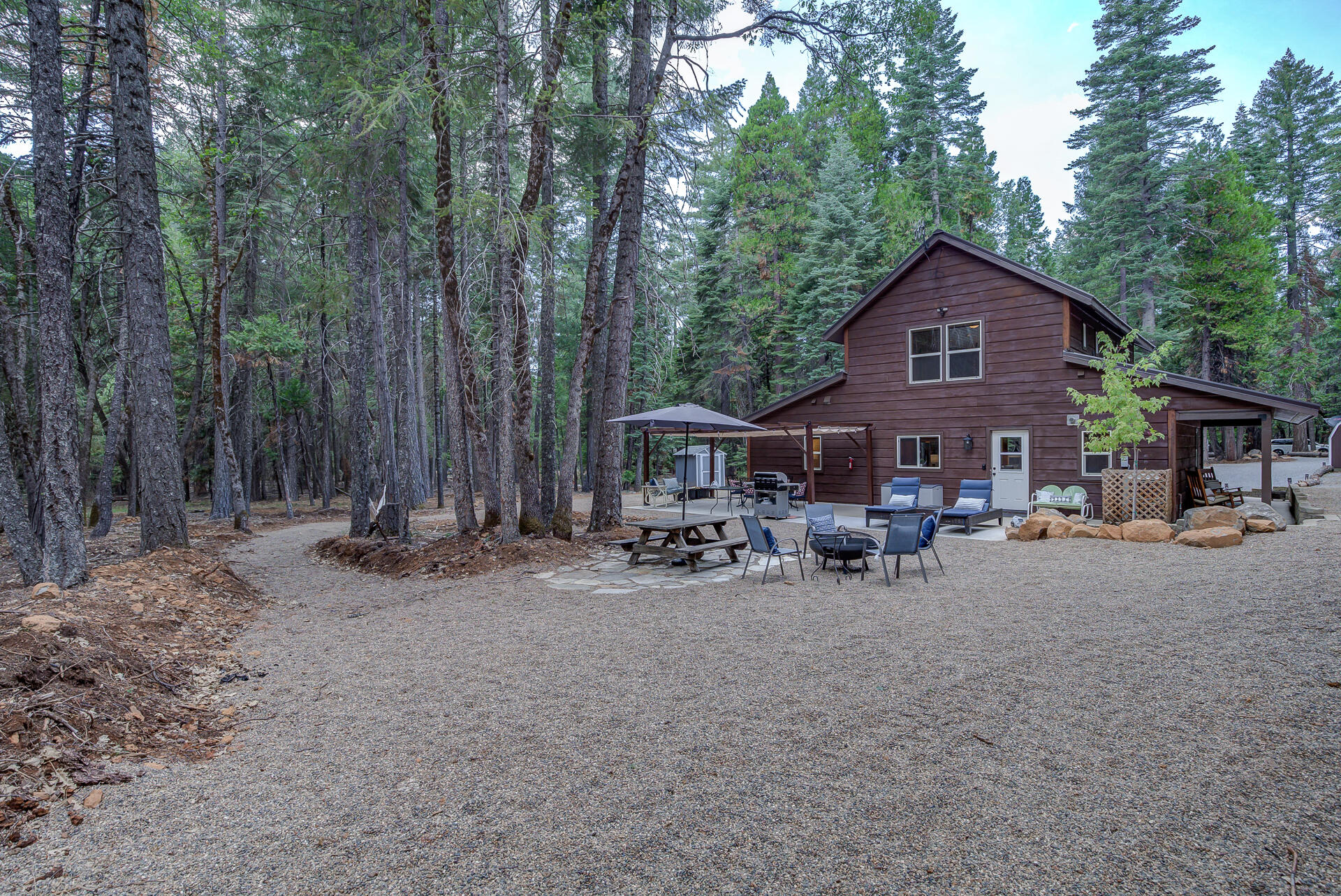 34607 Mountain Haven Road Shingletown, CA 96088 - Photo 45 of 63 a view of a house with a yard and sitting area