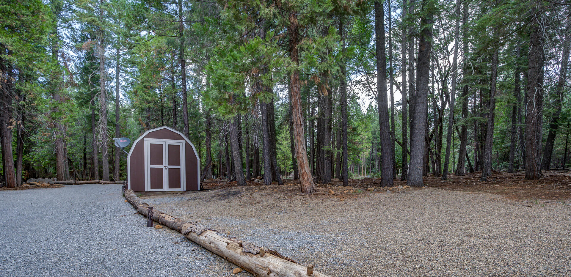 34607 Mountain Haven Road Shingletown, CA 96088 - Photo 47 of 63 a view of a backyard with large trees and wooden fence