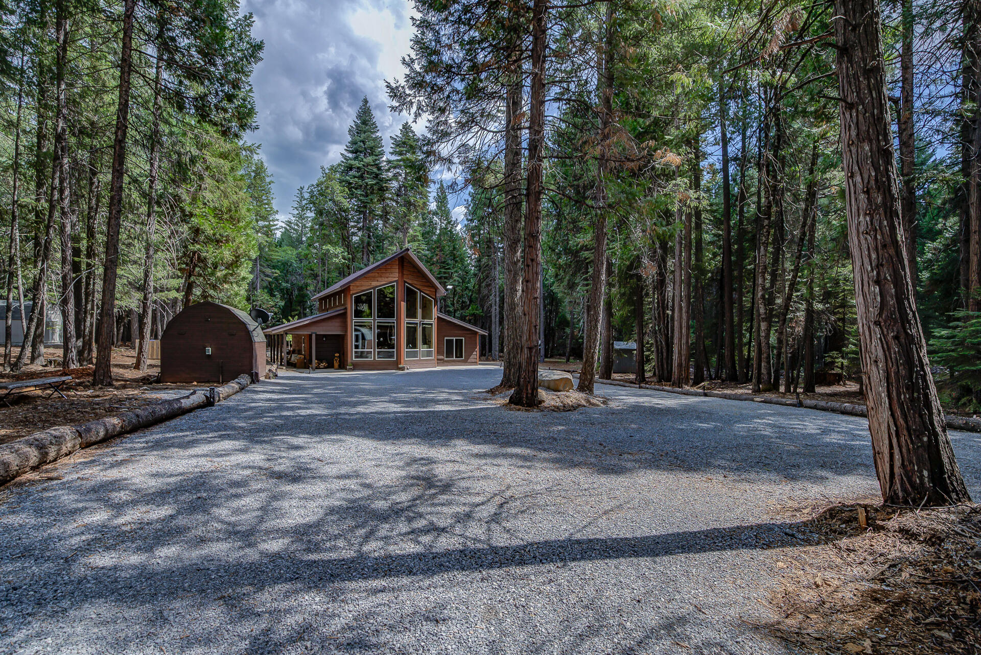 34607 Mountain Haven Road Shingletown, CA 96088 - Photo 58 of 63 a wooden house with trees in the background