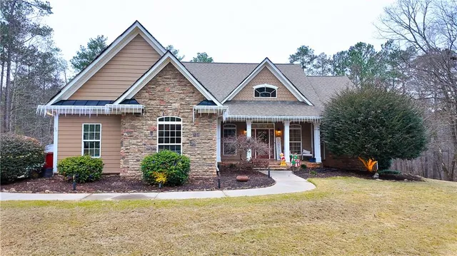 a front view of a house with a yard and porch