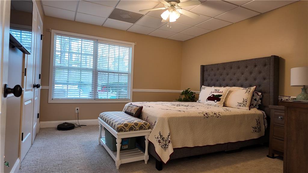 8179 Pineview Court Villa Rica, GA 30180 - Photo 30 of 38 a bedroom with a bed and a chandelier