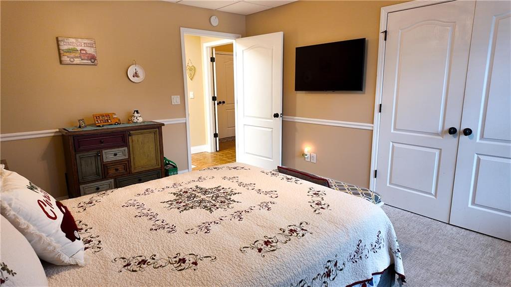 8179 Pineview Court Villa Rica, GA 30180 - Photo 32 of 38 a bedroom with a bed and a flat screen tv