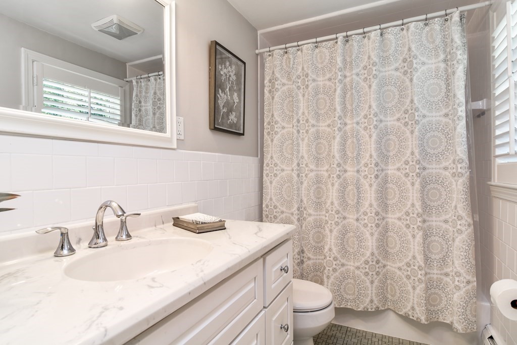 9 Longmeadow Road Medfield, MA 02052 - Photo 14 of 31 a bathroom with a granite countertop sink and a toilet