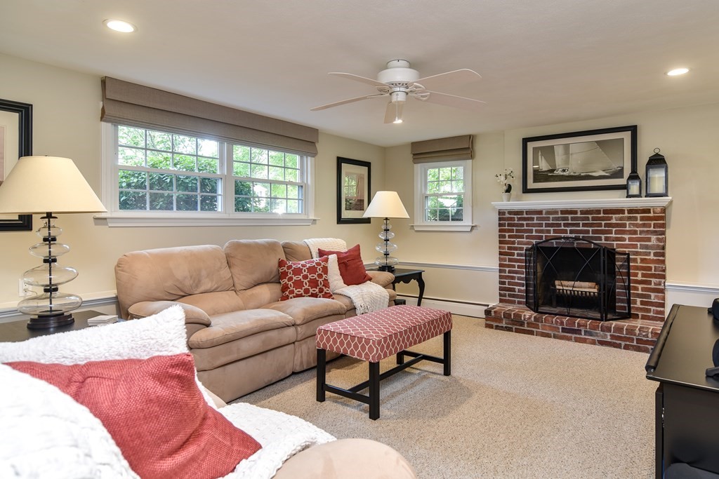 9 Longmeadow Road Medfield, MA 02052 - Photo 18 of 31 a living room with furniture a large window and a fireplace