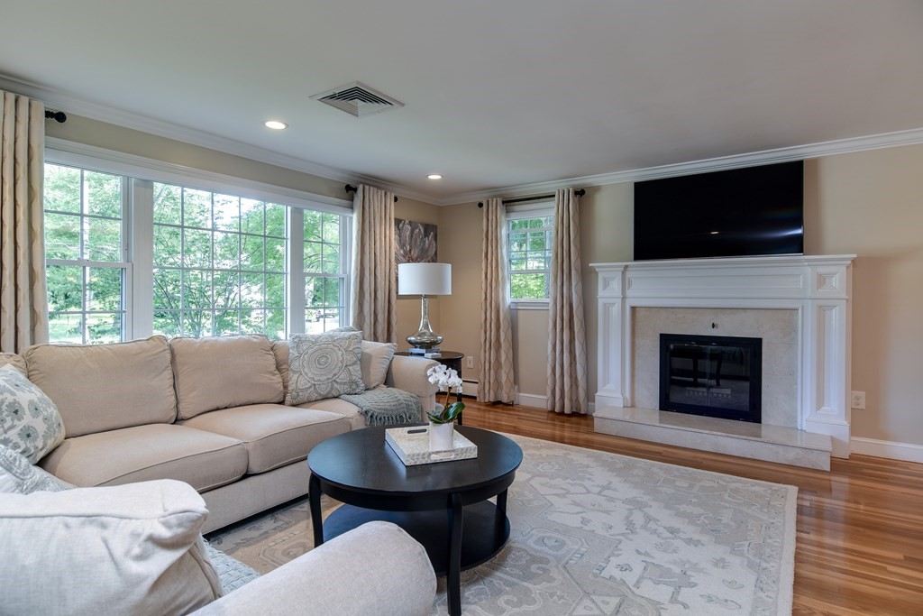 9 Longmeadow Road Medfield, MA 02052 - Photo 4 of 31 a living room with furniture a flat screen tv and a fireplace