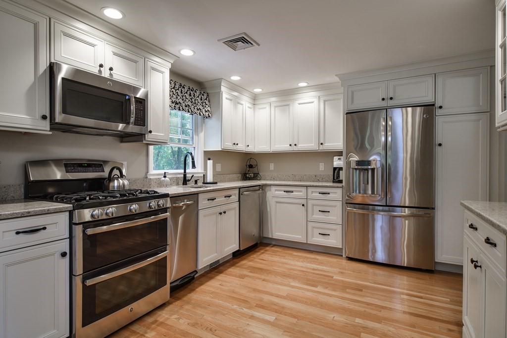 9 Longmeadow Road Medfield, MA 02052 - Photo 9 of 31 a kitchen with stainless steel appliances a stove a sink and a microwave