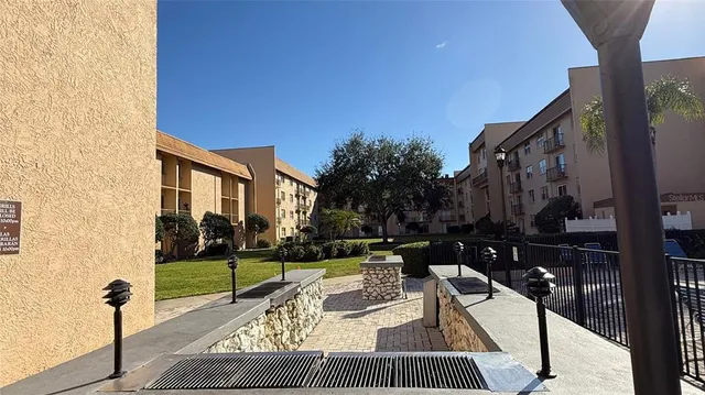 a view of a patio with couches table and chairs and potted plants