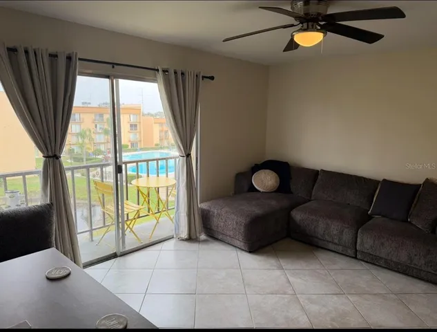 a living room with furniture and a large window